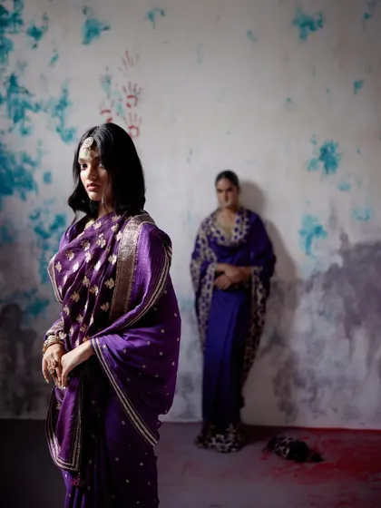 The regal beauty of a purple Banarasi saree. This image captures the rich texture and intricate gold motifs that make this weave a timeless classic, perfect for a bride's trousseau or a formal event.