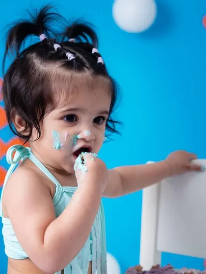 That little tongue-out expression is priceless! I aim to capture the full range of your baby's expressions, from sweet smiles to funny faces, during their cake smash session.