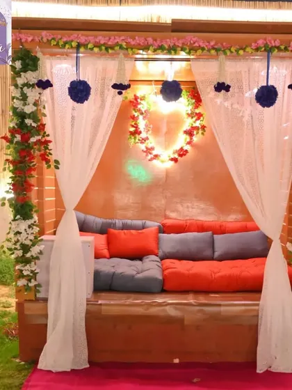 A beautifully decorated private seating area for couples. The space is adorned with floral arrangements and soft lighting to create a romantic atmosphere.
