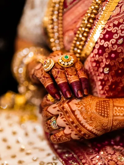 The final stain is proof of quality. This photo shows the beautiful, deep maroon color that develops from my 100% organic henna, perfectly complementing the bride's traditional attire and gold jewelry.