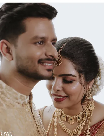 A tender moment with the bride resting her head on the groom's shoulder.