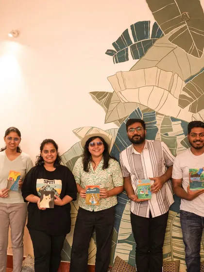 A group of participants proudly holding their finished paintings from our kitten art event.