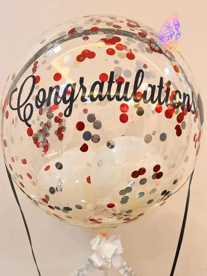 A close-up on the 'Congratulations' balloon, showing the fun confetti mix and the little butterfly detail we added for an extra touch of whimsy.