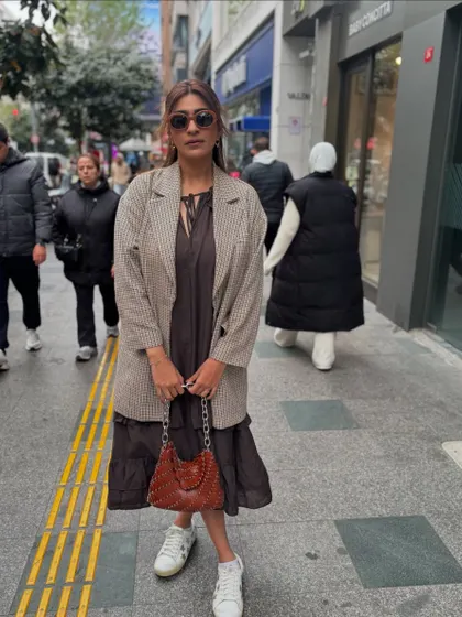 A dress-and-blazer combo is my go-to for a city day. Here, I've layered a houndstooth blazer over a simple tiered dress, finished with sneakers for comfort.