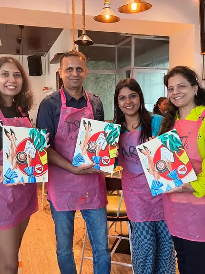 A group of four holding up their abstract paintings. It's interesting to see the different interpretations of the same theme.