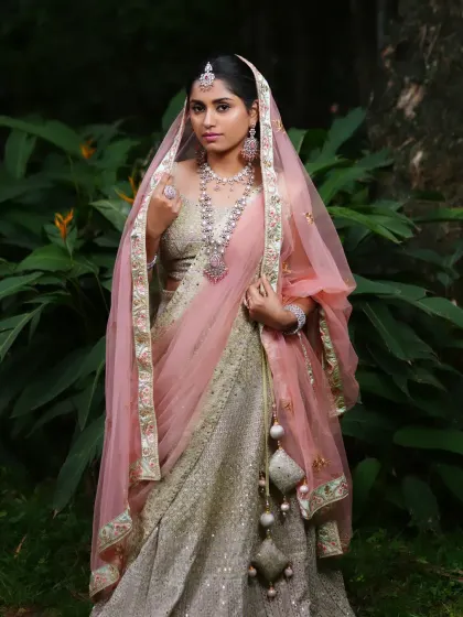 This bride looks ethereal in a pastel lehenga and a Victorian-Polki jewellery set with pink stones. This is a perfect example of a soft, romantic reception look.