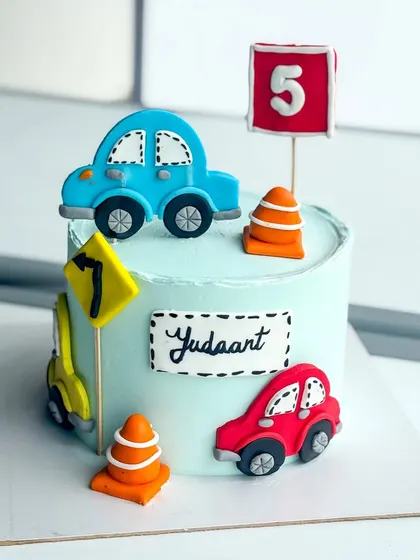 The full setup for the car-themed celebration cake.