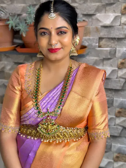 Dr. Gritha looking gorgeous for her house warming ceremony. A classic South Indian look with a red lip and traditional jewelry.
