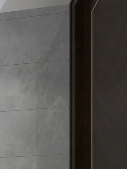 A detail shot of a wardrobe concept combining dark wood veneer with a grey marble-finish panel, showcasing our ability to work with luxurious and contrasting materials.