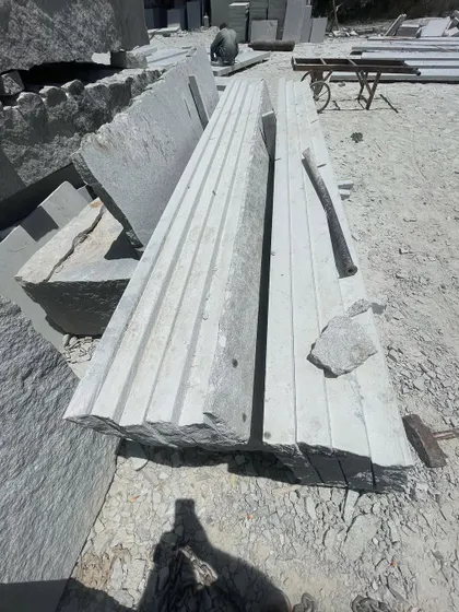 A large piece of stone being carved and shaped for a custom project.