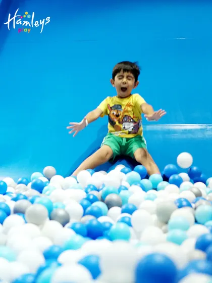 The excitement is real! This little adventurer is captured mid-air, showing the pure energy and joy that my slides and ball pits bring to every child's visit.