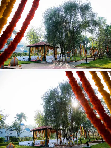 A wide shot of an outdoor wedding mandap, with sunlight filtering through the trees and colorful garlands, creating a magical ambiance.
