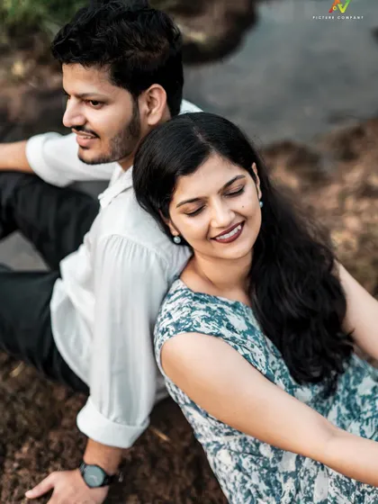 A peaceful moment with the couple sitting back-to-back, capturing a sense of quiet companionship.