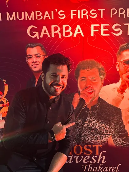 Pointing to my picture on the event banner. It's a reminder of the responsibility I have to make sure everyone who attends has an amazing time.
