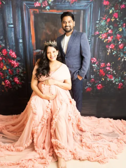 A regal portrait of the expecting parents. The crown on the mother-to-be adds a touch of royalty to this beautiful family picture.
