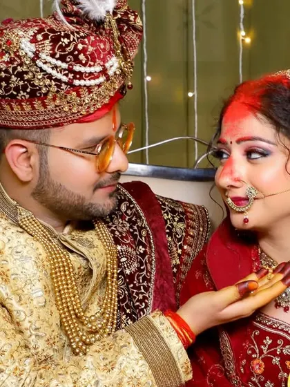An intimate moment during the wedding rituals, where the groom applies sindoor. We capture these traditions with care.