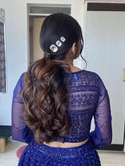 A view of the chic and modern ponytail that we paired with her blue lehenga. The crystal hair accessories add the perfect amount of sparkle.