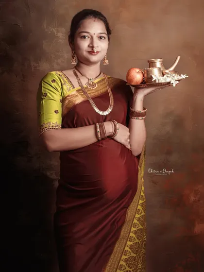 A graceful portrait of a mom-to-be in a traditional saree, holding a platter of offerings, symbolizing prosperity and well-being.