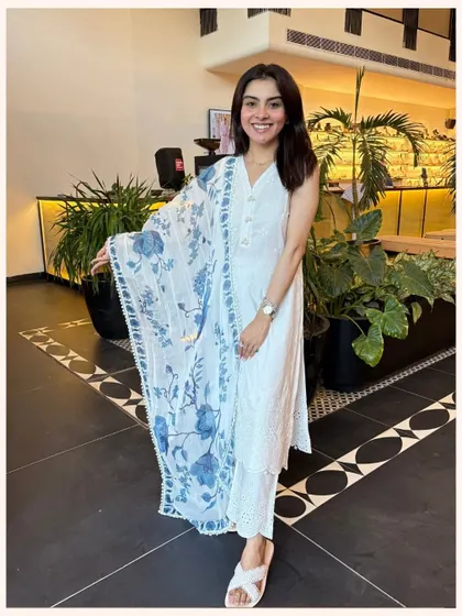 A classic white kurta with a twist. This set features a stunning blue floral printed dupatta that adds a vibrant pop of color.