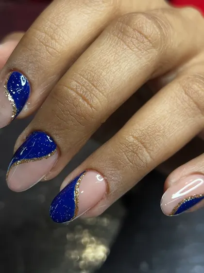A bold design using royal blue glitter polish and negative space.