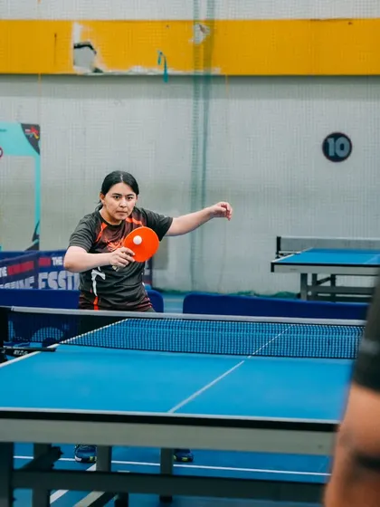 An employee from Gameskraft focuses on her serve during a table tennis match. Our multi sport events give everyone a chance to participate, whether they prefer the fast pace of badminton or the precision of TT.