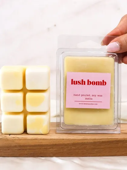 Soothing scents, melting softly. A hand holds up our 'Lush Bomb' wax melt, ready to be used.