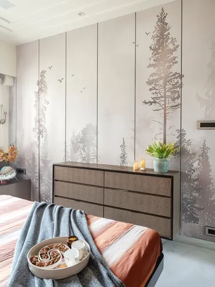 A key feature of this room is the serene, forest-themed wallpaper that covers an entire wall. It acts as a calming mural and pairs beautifully with the simple, modern lines of the six-drawer dresser.