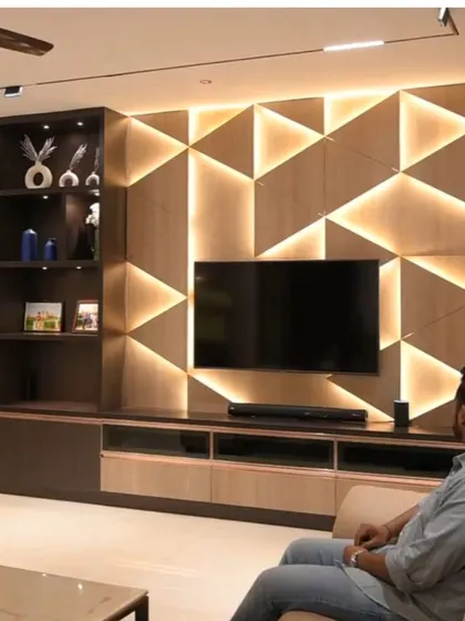 A stunning example of architectural lighting. The geometric TV wall is backlit with our automated LED strips, creating a dramatic and futuristic effect.