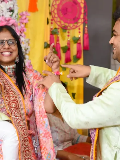 A candid moment of playful interaction between guests at the Mehendi ceremony.