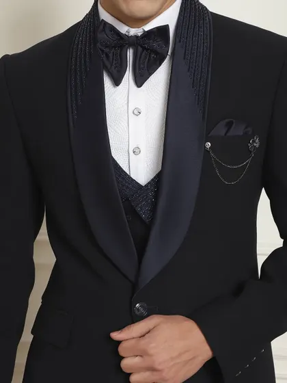 A closer look at the details of our designer tuxedo, featuring a unique bow tie and embellished lapels.