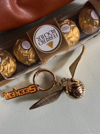 A detailed shot of the Golden Snitch and "Seeker" keychain, a magical accessory for any Harry Potter fan.