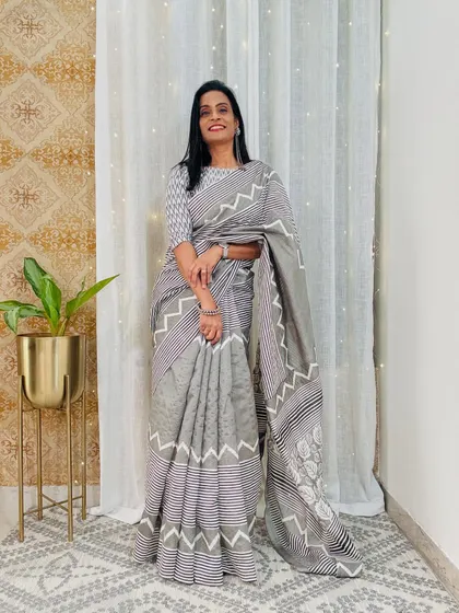 This grey saree with a geometric print is a modern and chic option for the office. It's a versatile piece that can be styled in many ways.