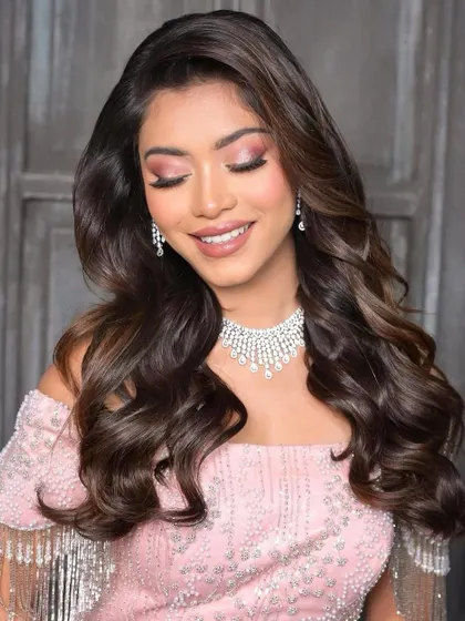 Soft, off-the-shoulder waves are perfect for a reception glam look. This style is minimal yet incredibly classy and highlights the bride's features beautifully.