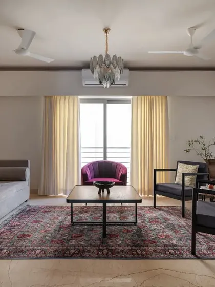 The living room in the Earthen Anthem penthouse, seen through sliding panels of wood and fluted glass, offering a flexible and layered living space.
