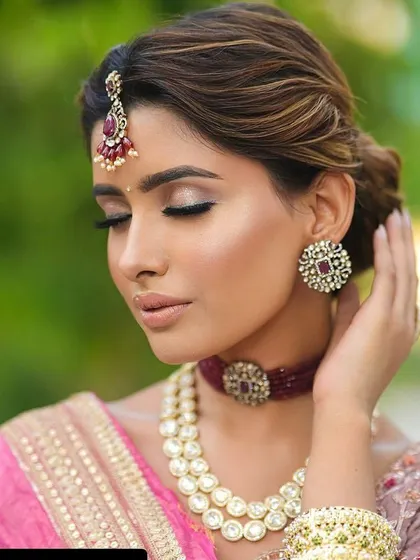 A soft, messy updo with loose, face-framing strands gives a romantic and modern feel. This style is perfect for a bride who wants to look elegant yet feel comfortable.