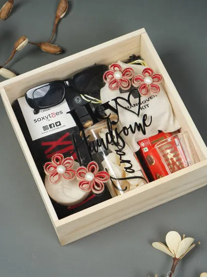 Another option for a men's birthday hamper, this one is packed in a rustic wooden box and includes sunglasses, a "hangover kit," and other fun essentials.