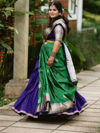 Our client looks stunning, showing off the beautiful flow of her green and royal blue half saree. We ensure every outfit has that perfect twirl factor.