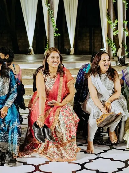 Guests enjoying the Sangeet performances, their happy faces reflecting the success of the evening. A happy audience is the ultimate goal.