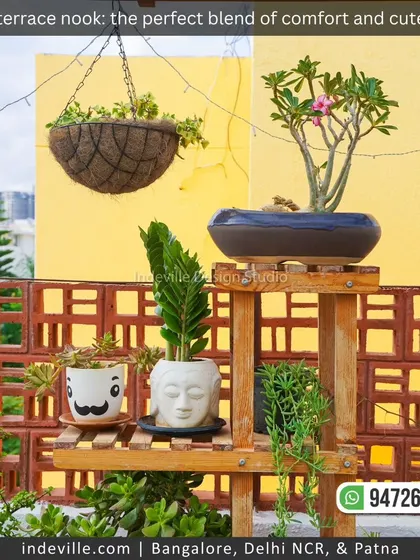 A detail shot of the custom wooden plant shelf, featuring a mix of hanging plants and cute planters like the Buddha head and mustache pot. These small touches make a garden feel personal and curated.