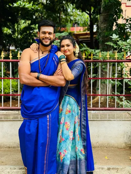 A classic pose showing the beautiful color coordination between the couple's outfits.