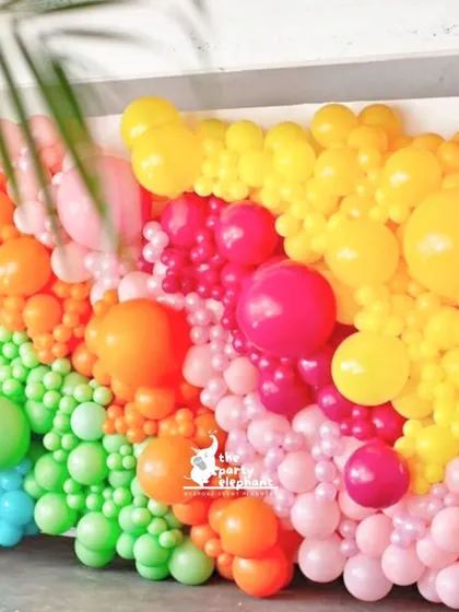 Balloon walls are a fantastic way to add a pop of color. For the art party, I created this textured rainbow balloon wall, which served as a vibrant and fun piece of decor.