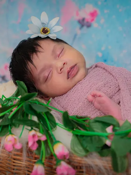 A sleeping baby adorned with flowers. This artistic composition combines the innocence of the newborn with the beauty of nature.