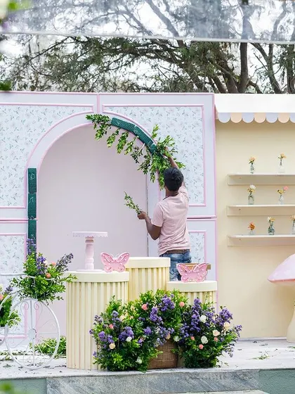 A little peek behind the curtain! Here's a shot of my team member putting the finishing floral touches on Maanvi's flower garden backdrop. We handle every aspect of the setup so you can relax and enjoy the day.