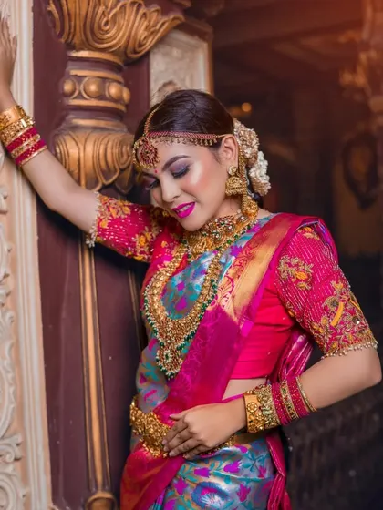 A graceful pose against a pillar, this shot captures the elegance of the entire bridal ensemble.