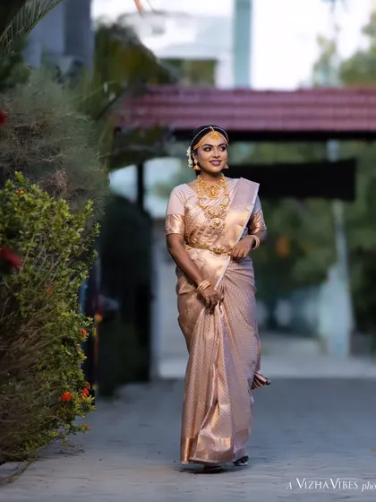 A full-length shot of a model showcasing a traditional muhurtham look, walking gracefully.