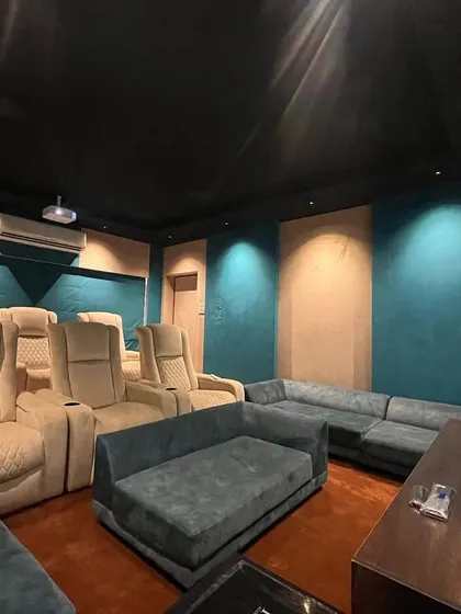 This wide shot shows the flexible seating arrangement, with a large sofa in addition to the premium recliners.