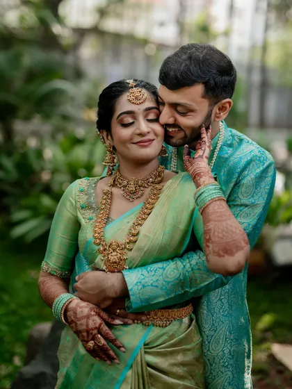 A tender moment between the couple, showcasing their beautiful coordinated outfits. Our goal is to capture the subtle emotions and details that make your wedding portraits special.