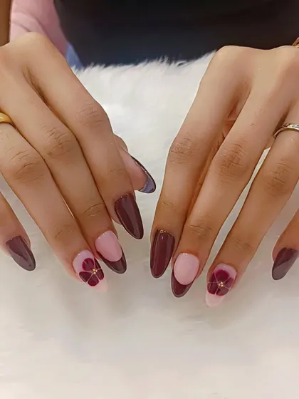 Nails as rich as the wine we’re celebrating with. This beautiful set features deep wine-colored nails with a half-moon design and delicate floral accents.