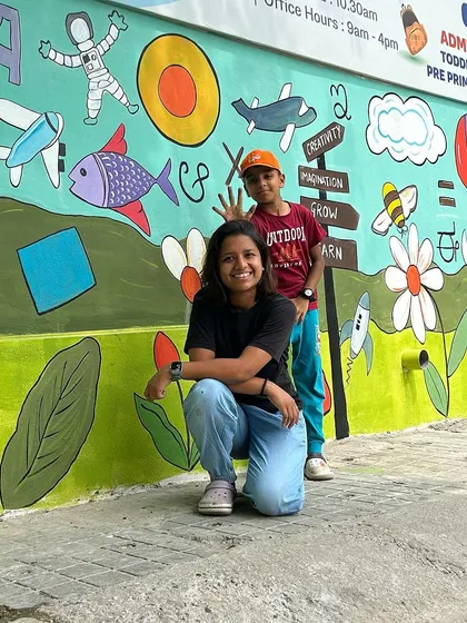 A duplicate image of me and my helper in front of the large, colorful wall.