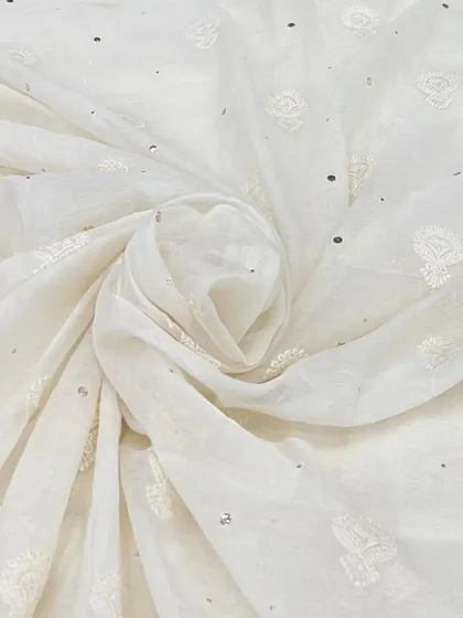 This off-white Mul Chanderi with delicate buti embroidery and scattered sequins is a timeless classic for elegant kurtas and suits.